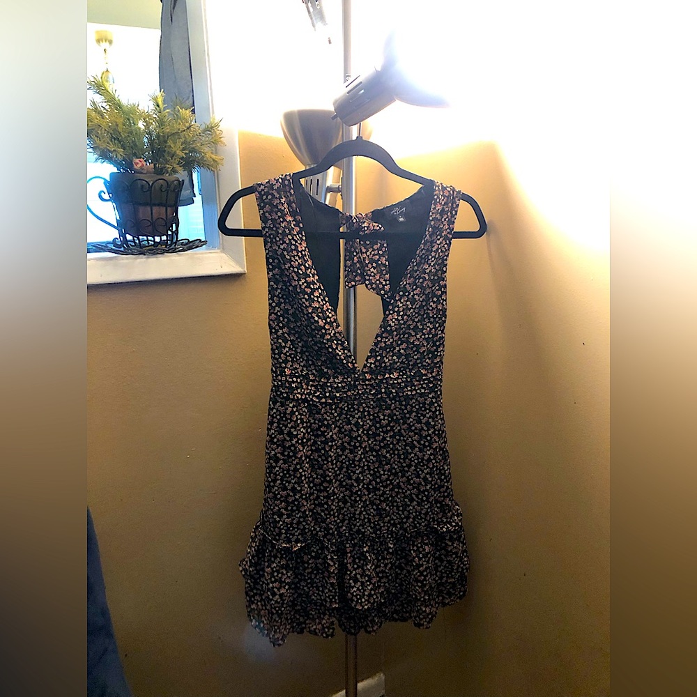 Very cute summer dress, low cut in front and open back.